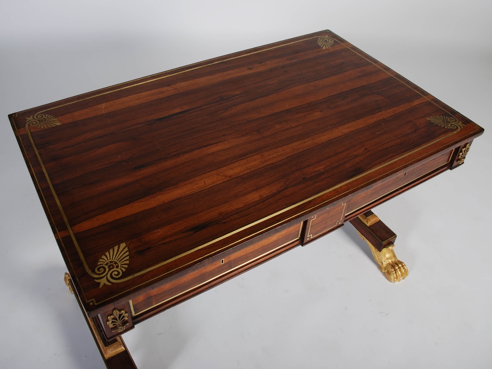 A Regency rosewood, brass inlaid and gilt wood library table, the rectangular top with a brass - Image 7 of 7