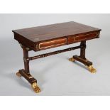 A Regency rosewood, brass inlaid and gilt wood library table, the rectangular top with a brass