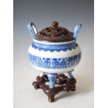 A Chinese porcelain blue and white censer, dark wood cover and stand, Qing Dynasty bearing