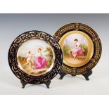 Two Vienna porcelain cobalt blue ground cabinet plates, one decorated with a girl sitting on a bench