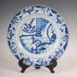 A Chinese porcelain blue and white dish, Qing Dynasty, decorated with figure on bridge, pavilions
