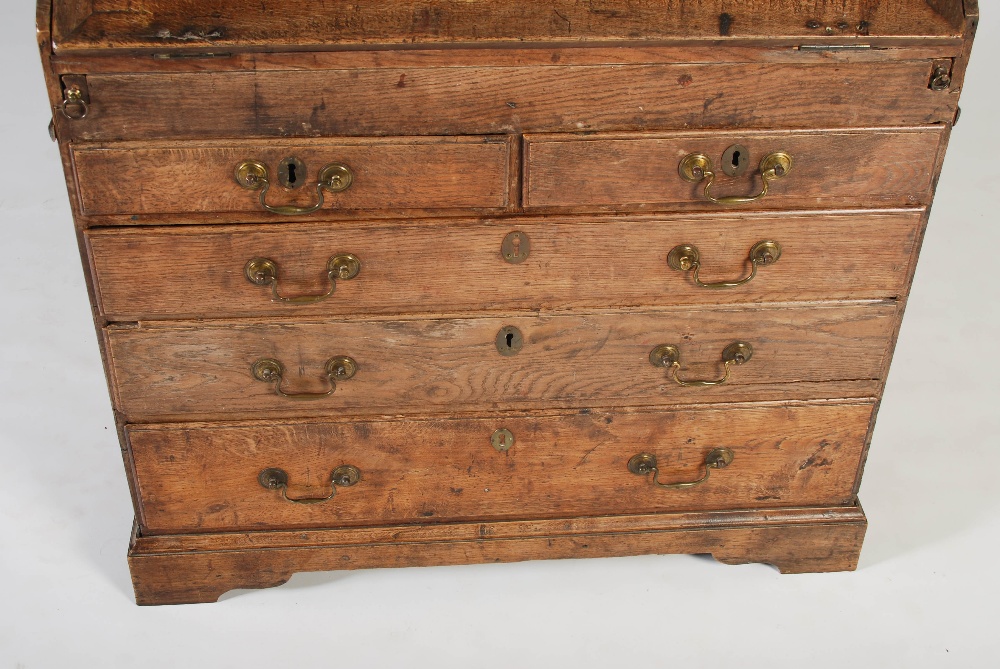 A George III oak bureau bookcase, the double domed moulded cornice above a pair of panelled cupboard - Image 5 of 6