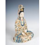 A Japanese Satsuma pottery figure of Guanyin, Meiji period, decorated with blue, red and green