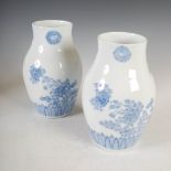 A pair of Japanese Hirado porcelain vases, decorated with peony, butterfly and floral Mons above a