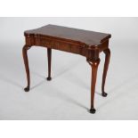 A George III mahogany concertina action card table, the shaped rectangular top opening to a green