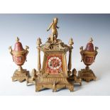 A late 19th century gilt metal and porcelain mounted clock garniture in the Egyptianesque style, the