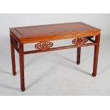 A Chinese dark wood console table, the rectangular panelled top above a frieze set with six