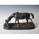 A late 19th century bronze figure group of hunter, horse and hound, on naturalistic oval plinth