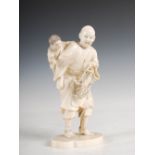 A Japanese ivory okimono of a crab, fisherman and attendant child, Meiji period, 15.5cm high.