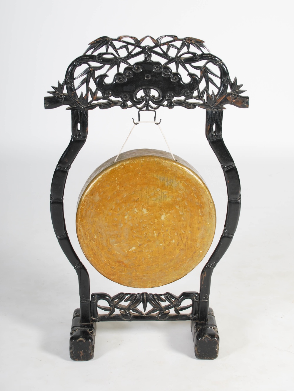 A Chinese gong and stand, late Qing Dynasty, the stand carved and pierced with bamboo stems