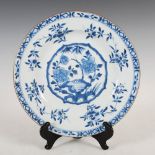 A Chinese porcelain blue and white dish, Qing Dynasty, the central roundel decorated with bamboo and