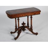 A Victorian walnut and ebonised card table, the hinged revolving rectangular top opening to a puce