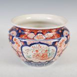 A Japanese Imari jardiniere, decorated with three panels of baskets issuing peony, 22.5cm diameter x