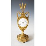 A Regency ormolu mantel clock, the white enamel dial with Roman numerals and twin train movement