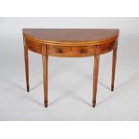 A George III mahogany and satinwood banded demi lune card table, the hinged top opening to a puce