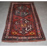 A late/early 20th century Karabagh rug, Chondoresk, the rectangular madder field centred with two