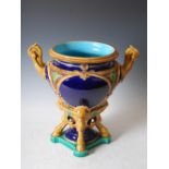 A late 19th century Majolica pottery twin handled jardiniere, the tapered cylindrical bowl with mask