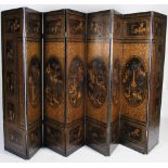 A Chinese lacquered eight fold screen, Qing Dynasty, decorated with oval panels of pavilions and