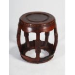 A Chinese dark wood barrel shaped stool, the circular top with burr wood panelled insert within a