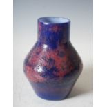 An early Monart stoneware vase, shape B, mottled purple and pink glass with surface textured
