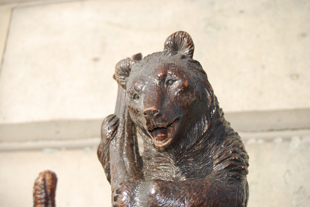 A late 19th/ early 20th century Black Forest carved bear hall stand, carved with a bear holding a - Image 3 of 3