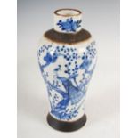 A Chinese porcelain blue and white crackle glazed jar, Qing Dynasty, decorated with peacocks on