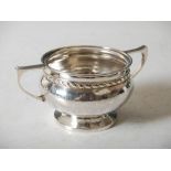 An Arts & Crafts silver twin handled bon-bon dish, Birmingham, 1926, makers mark of A. E. Jones,