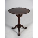 A 19th century mahogany bird cage snap top tripod table, the hinged circular top with a pie crust