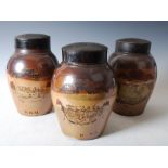 Three 19th century stoneware tobacco jars and covers, one decorated with worn hand painted