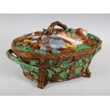 A Mintons Majolica pottery game pie dish and cover, the cover moulded in relief with pear and