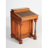 A Victorian mahogany and parcel gilt Davenport, the rectangular top opening to a fitted interior