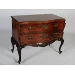 A George III mahogany and ebony lined serpentine commode, the shaped rectangular top with carved