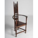 A 19th century oak caqueteuse armchair, the rectangular panelled back with rosette carved detail,