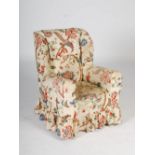 A Victorian mahogany wing armchair, the Calico upholstered back, arms and seat with loose floral