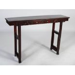 A Chinese dark wood altar table, the rectangular panelled top above a frieze carved with tripod