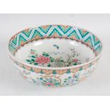 A late 19th/early 20th century Japanese porcelain bowl, decorated with a basket issuing peony and