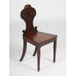 A 19th century mahogany hall chair, the shaped back with scroll detail and gadroon carved surmount