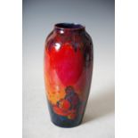 A rare Royal Doulton Sung Flambe vase by Charles Noke, decorated with a potter throwing a jar,