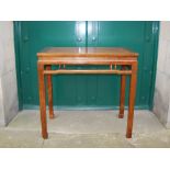 A Chinese figured wood alter table, Qing Dynasty, the panelled rectangular top above an open