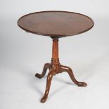 A George III mahogany bird cage snap top occasional table, the circular top with a slightly dished