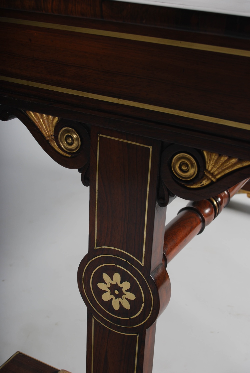 A Regency rosewood, brass inlaid and gilt wood library table, the rectangular top with a brass - Image 3 of 7