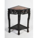 A Chinese dark wood corner shaped jardiniere stand, Qing Dynasty, the triangular shaped top with a