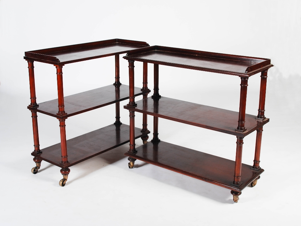 A pair of Victorian style mahogany three tier whatnots, the rectangular tiers with reeded edges,