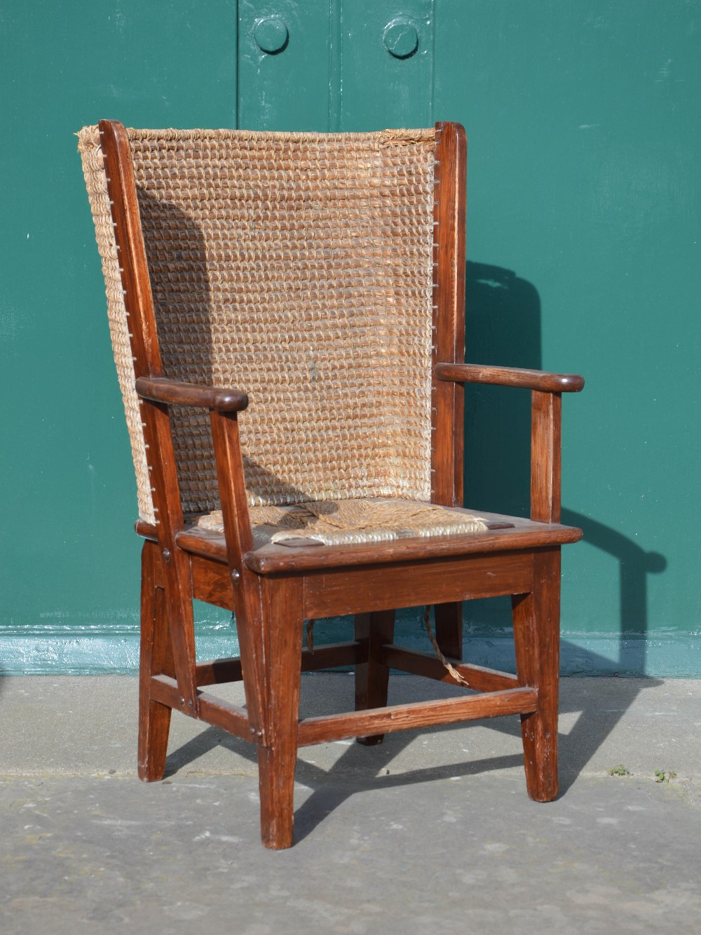 A late 19th/ early 20th century stained pine Orkney chair, with drop in seat, 84cm high.