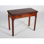 A George III mahogany tea table, the hinged rectangular top with a foliate carved edge above a plain