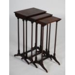 A nest of three 19th century rosewood occasional tables, the rectangular tops with burr wood
