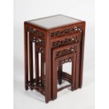 A quartetto of four Chinese dark wood occasional tables, late Qing Dynasty, the rectangular tops