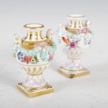 A pair of Dresden porcelain miniature twin handled urns, decorated with ribbon tied floral swags,