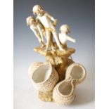 An early 20th century Vienna porcelain Art Nouveau style figure group of three boys pulling in