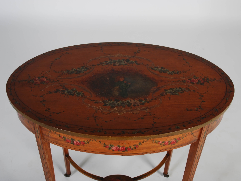 An Edwardian painted satinwood occasional table, the oval shaped top decorated with vignette of a - Image 2 of 5